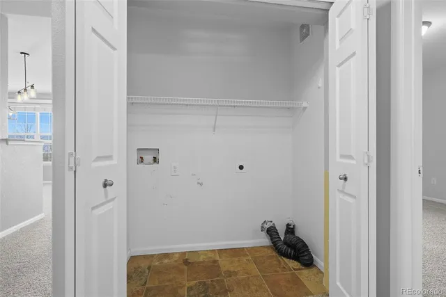 a view of an empty room and a window