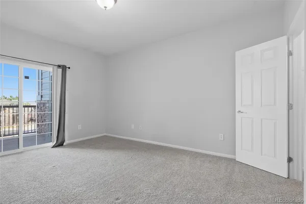 a view of an empty room and a window