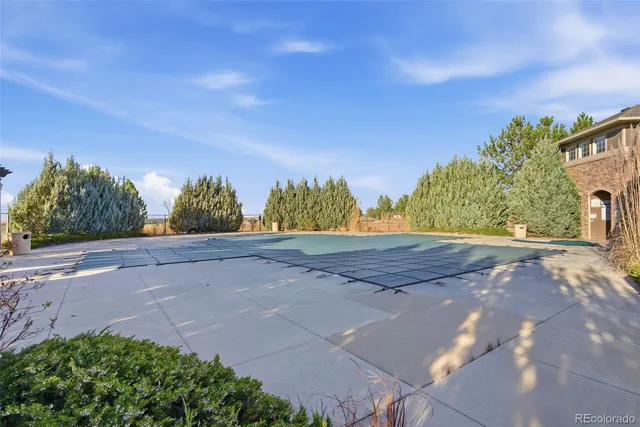 a view of a house with swimming pool and sitting area