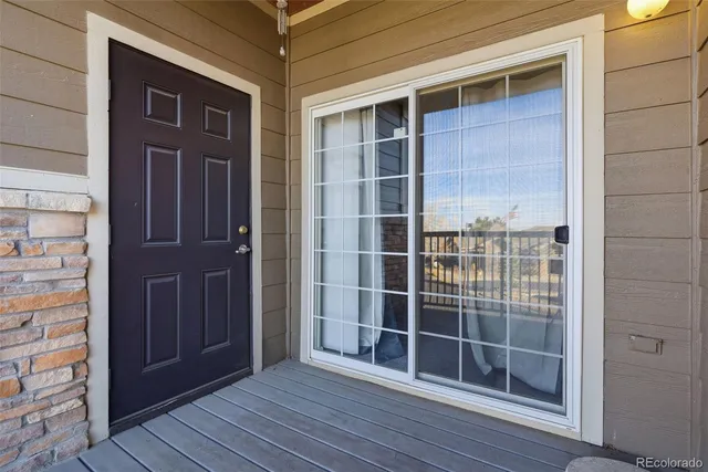 a view of wooden door and brick walls