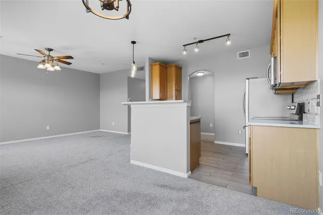 a view of a kitchen with a sink and a refrigerator