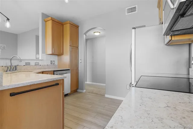 a kitchen with a sink and a refrigerator