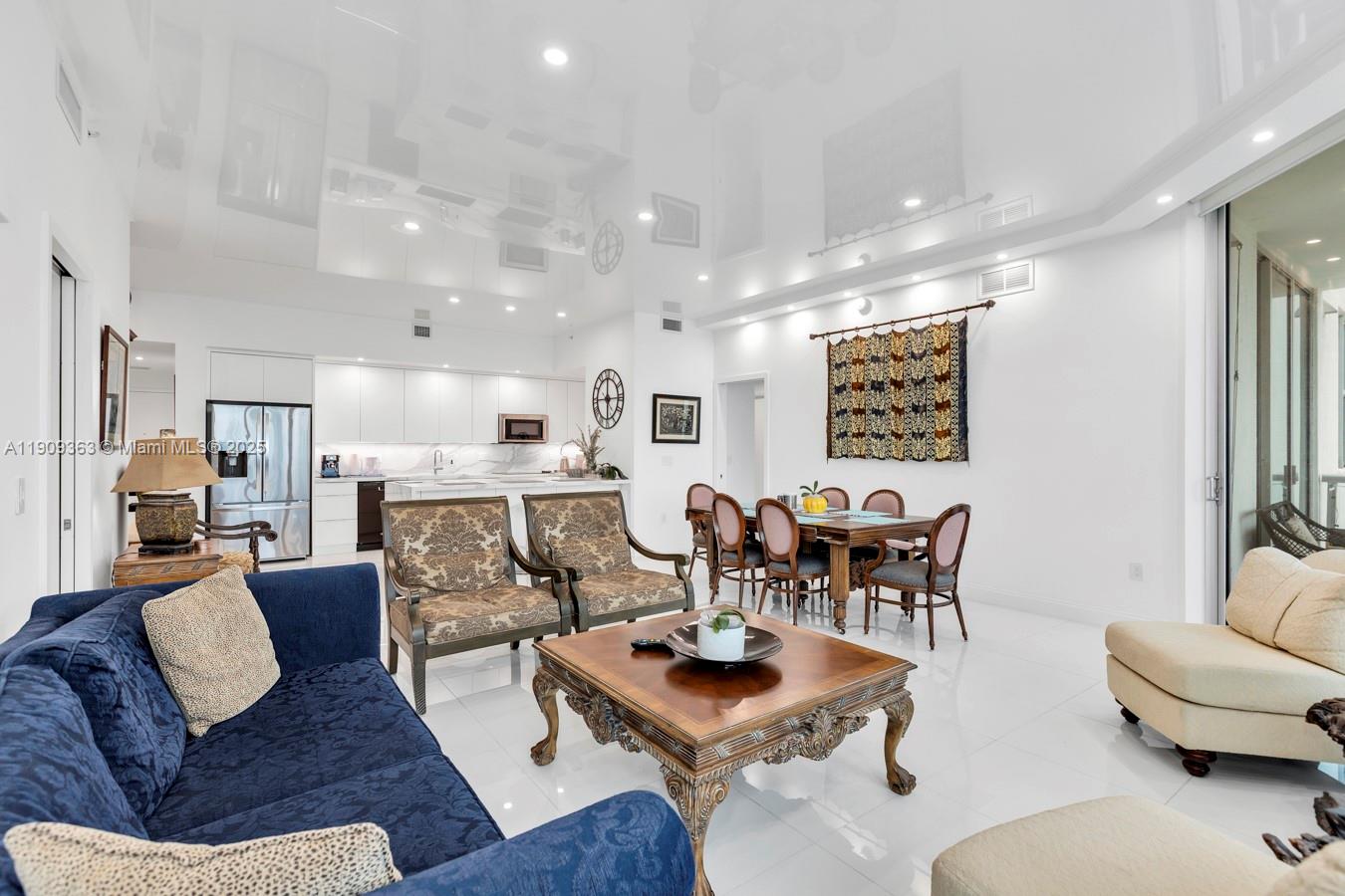 3131 Northeast 188th Street, Unit 21004 Aventura, FL 33180 - Photo 13 of 53 a living room with furniture kitchen view and a chandelier