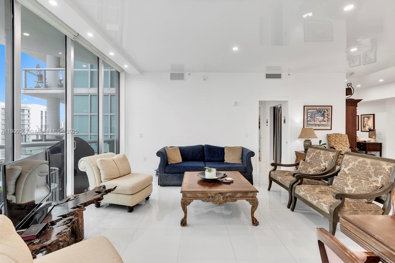 3131 Northeast 188th Street, Unit 21004 Aventura, FL 33180 - Photo 14 of 53 a living room with furniture and a large window