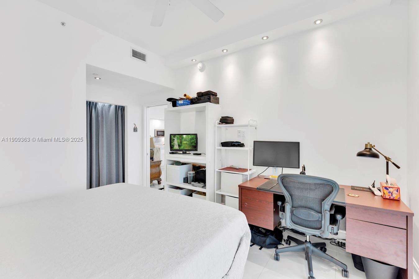 3131 Northeast 188th Street, Unit 21004 Aventura, FL 33180 - Photo 22 of 53 a bedroom with a bed and a desk