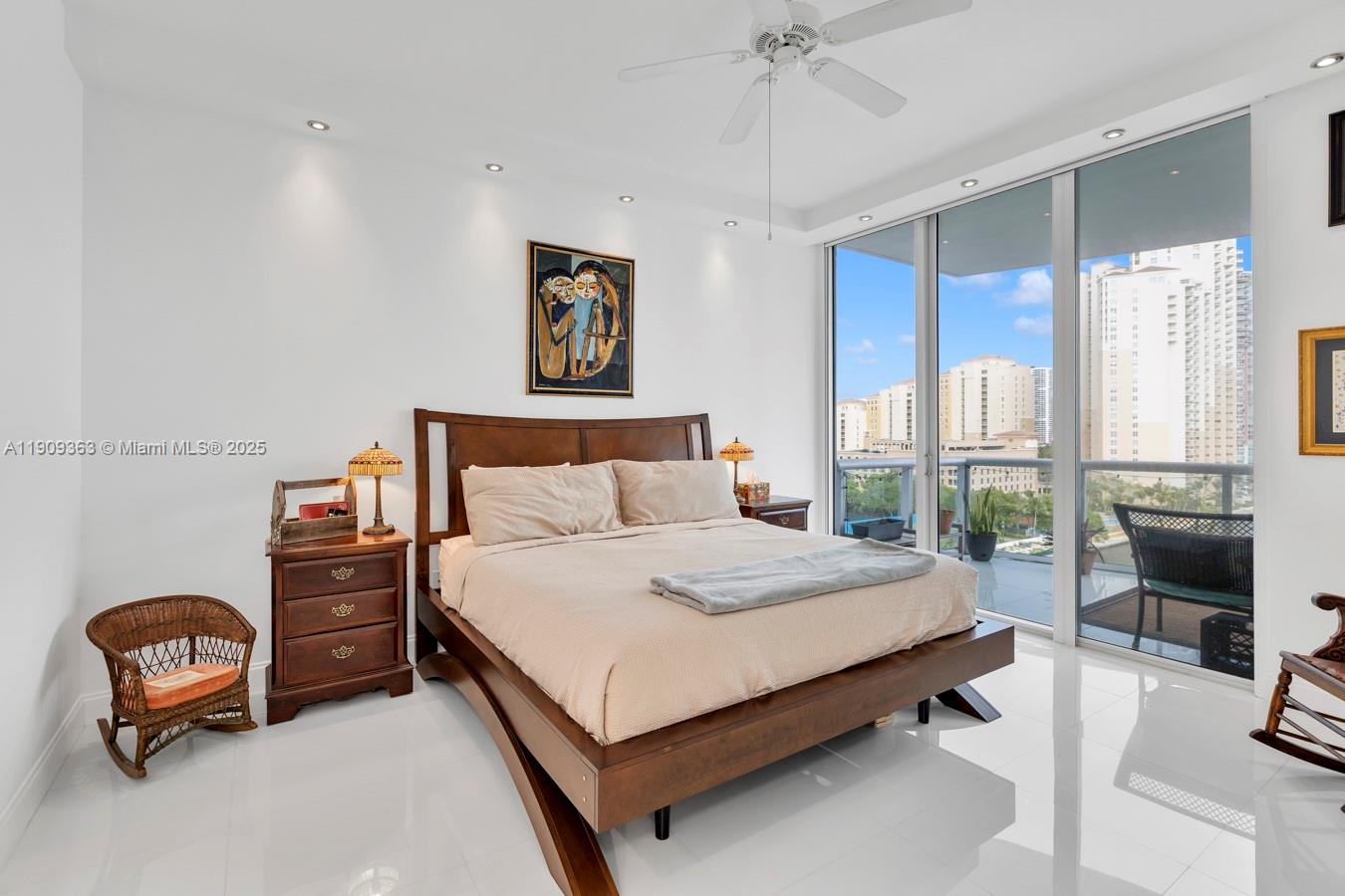 3131 Northeast 188th Street, Unit 21004 Aventura, FL 33180 - Photo 23 of 53 a bedroom with a bed and a chandelier