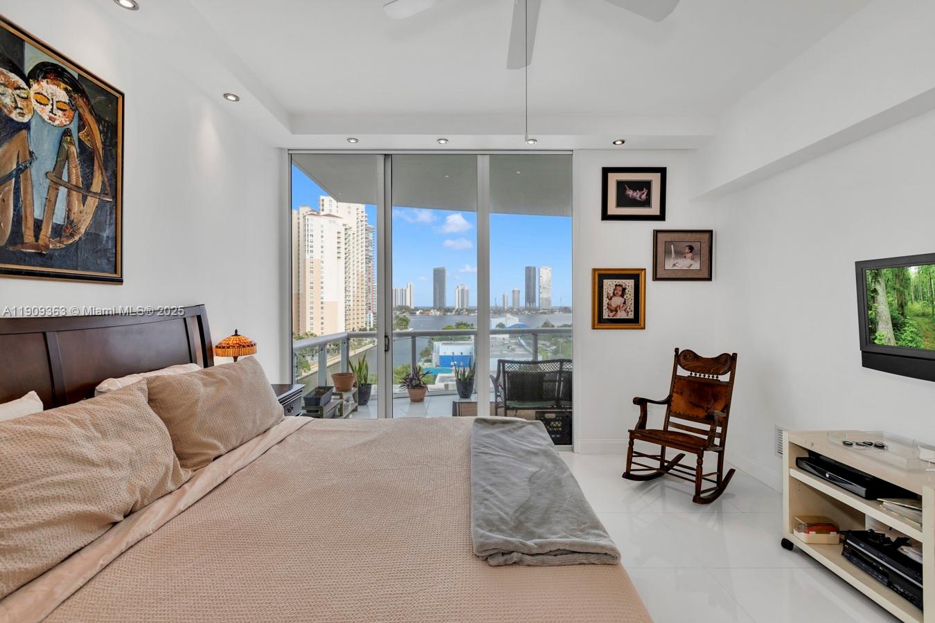 3131 Northeast 188th Street, Unit 21004 Aventura, FL 33180 - Photo 24 of 53 a bedroom with furniture and a chandelier
