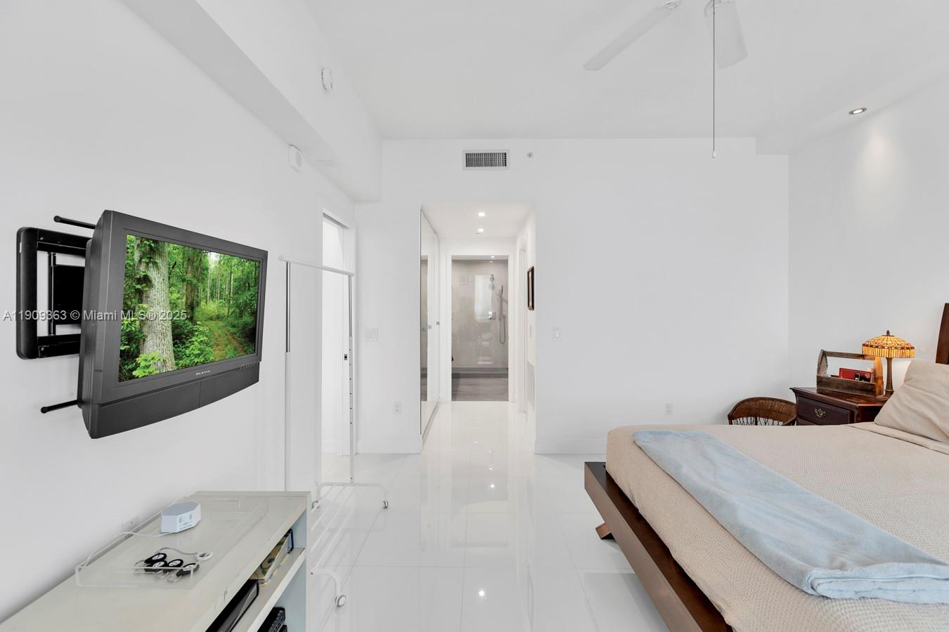 3131 Northeast 188th Street, Unit 21004 Aventura, FL 33180 - Photo 25 of 53 a bedroom with a bed and a window