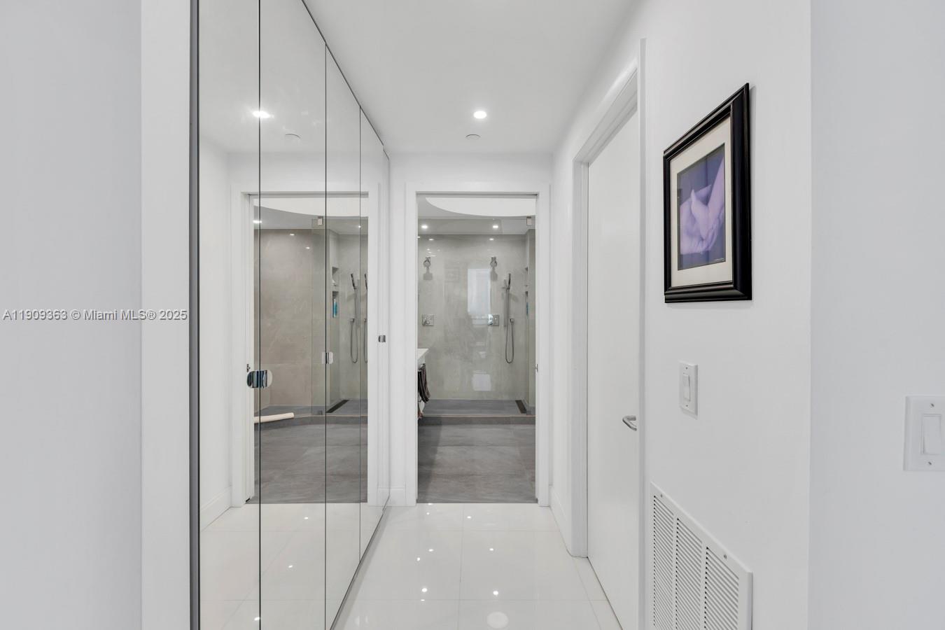 3131 Northeast 188th Street, Unit 21004 Aventura, FL 33180 - Photo 26 of 53 a bathroom with a glass shower door