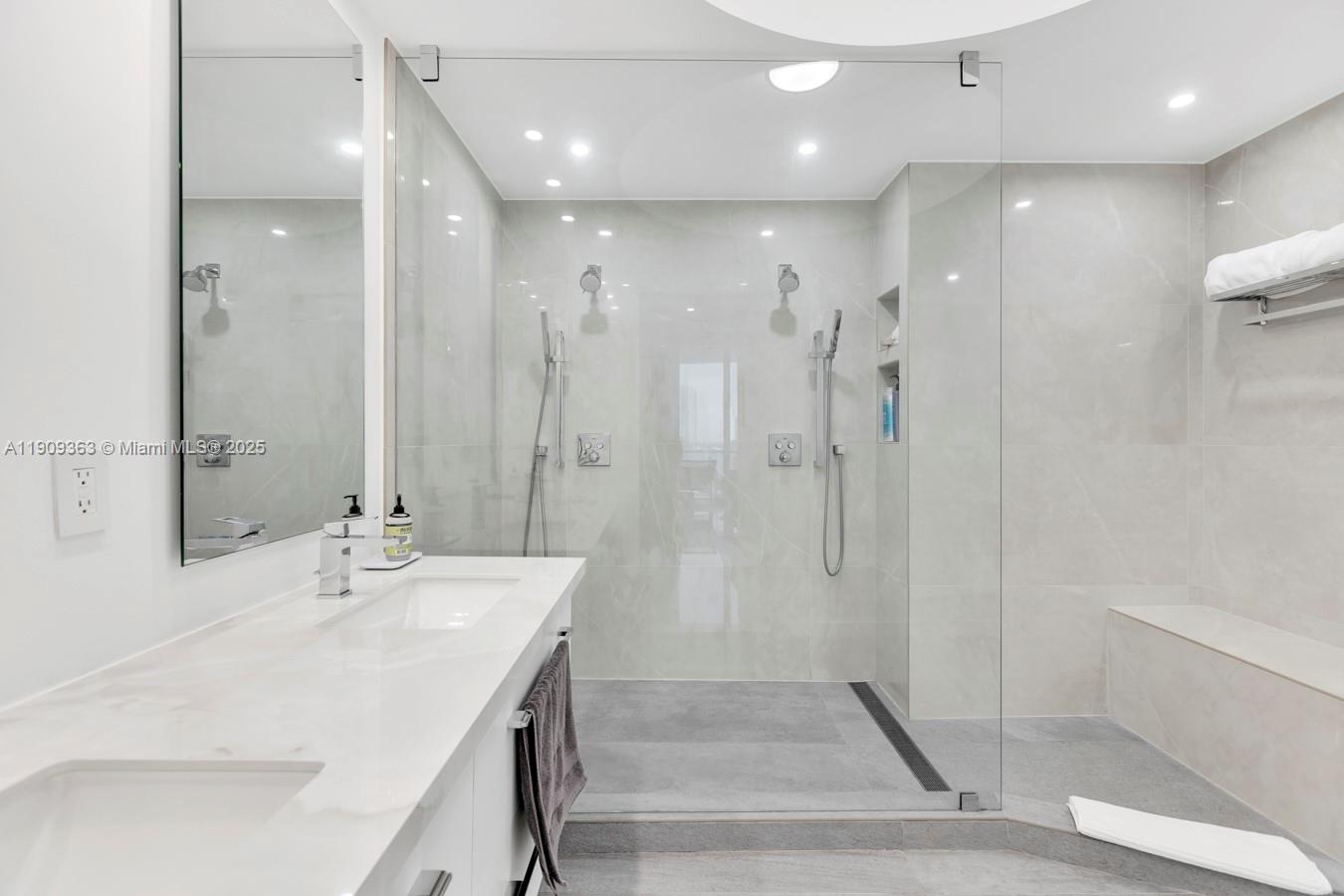 3131 Northeast 188th Street, Unit 21004 Aventura, FL 33180 - Photo 28 of 53 a bathroom with a shower sink and mirror