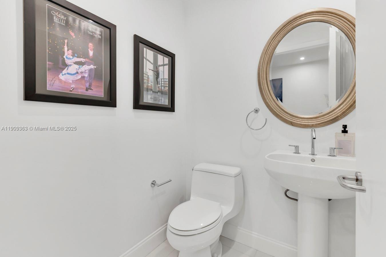 3131 Northeast 188th Street, Unit 21004 Aventura, FL 33180 - Photo 31 of 53 a bathroom with a toilet a sink and a mirror