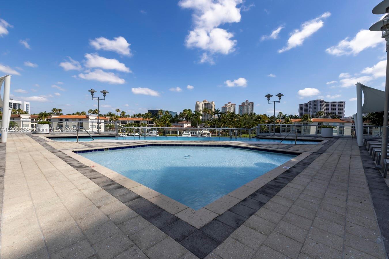 3131 Northeast 188th Street, Unit 21004 Aventura, FL 33180 - Photo 43 of 53 a view of a swimming pool with outdoor seating