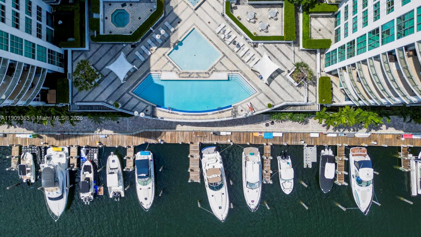 3131 Northeast 188th Street, Unit 21004 Aventura, FL 33180 - Photo 48 of 53 a view of a patio with table and chairs with wooden floor