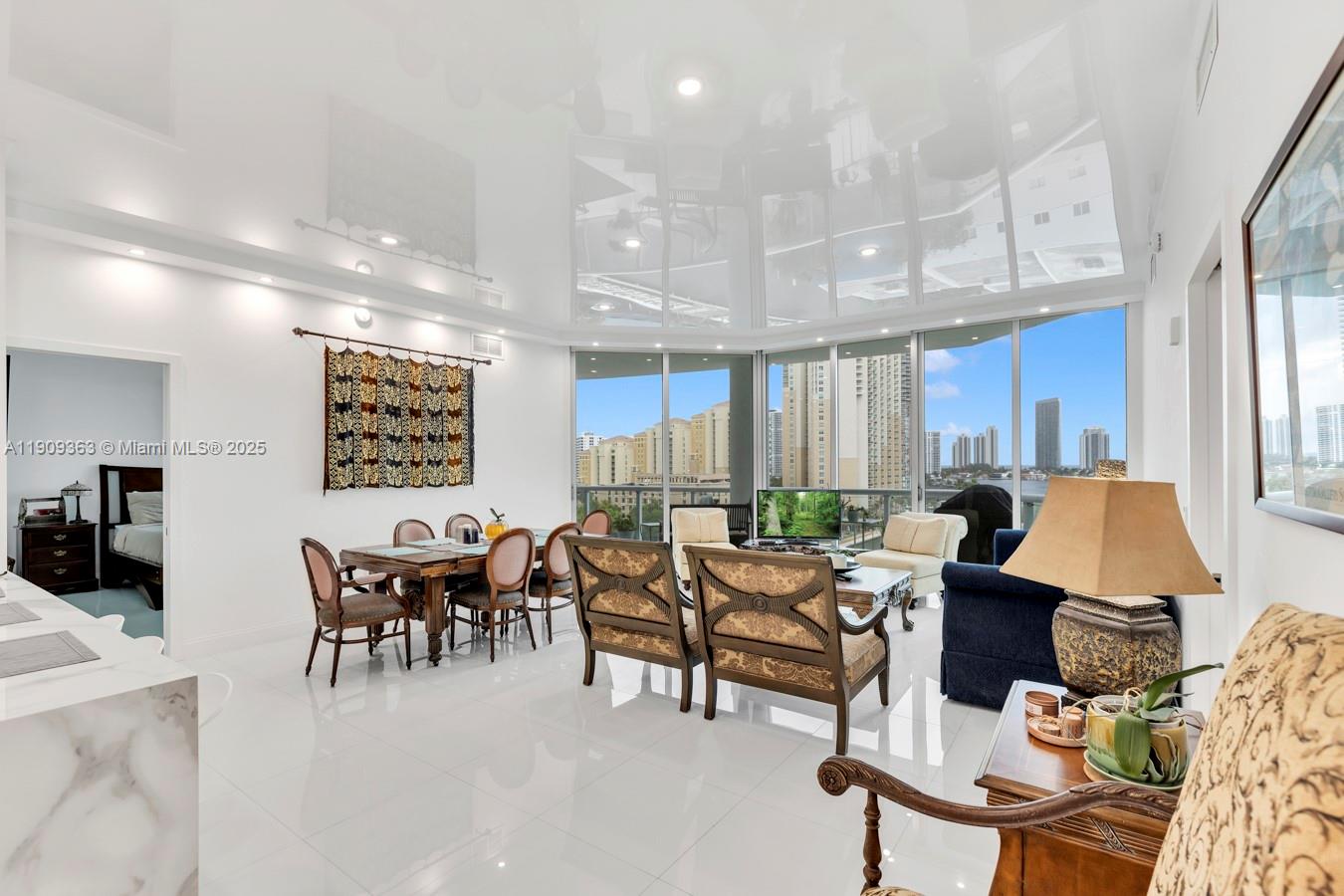 3131 Northeast 188th Street, Unit 21004 Aventura, FL 33180 - Photo 6 of 53 a living room with furniture a rug kitchen view and a large window