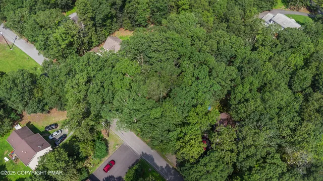 an aerial view of a house with yard