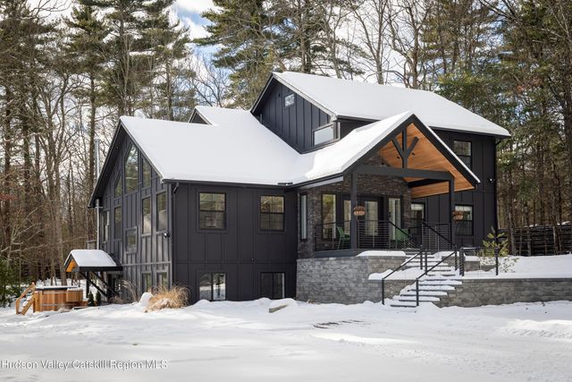a view of a house with a yard covered in snow