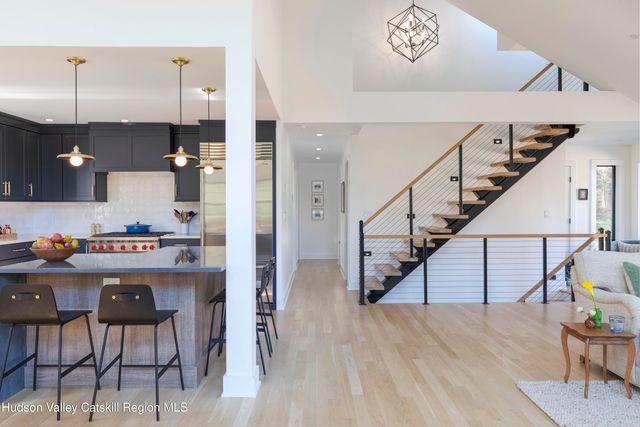 a dining room with furniture a rug and wooden floor