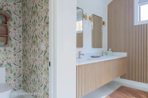 a kitchen with a sink and a mirror