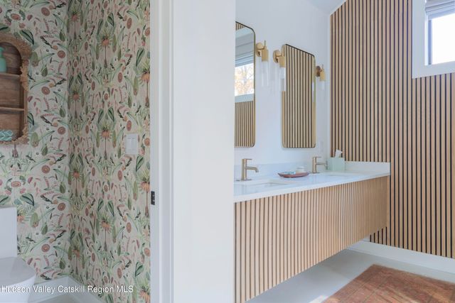 a kitchen with a sink and a mirror