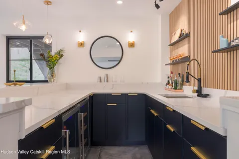 a kitchen with stainless steel appliances a table chairs refrigerator and cabinets