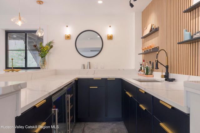 a kitchen with stainless steel appliances a table chairs refrigerator and cabinets