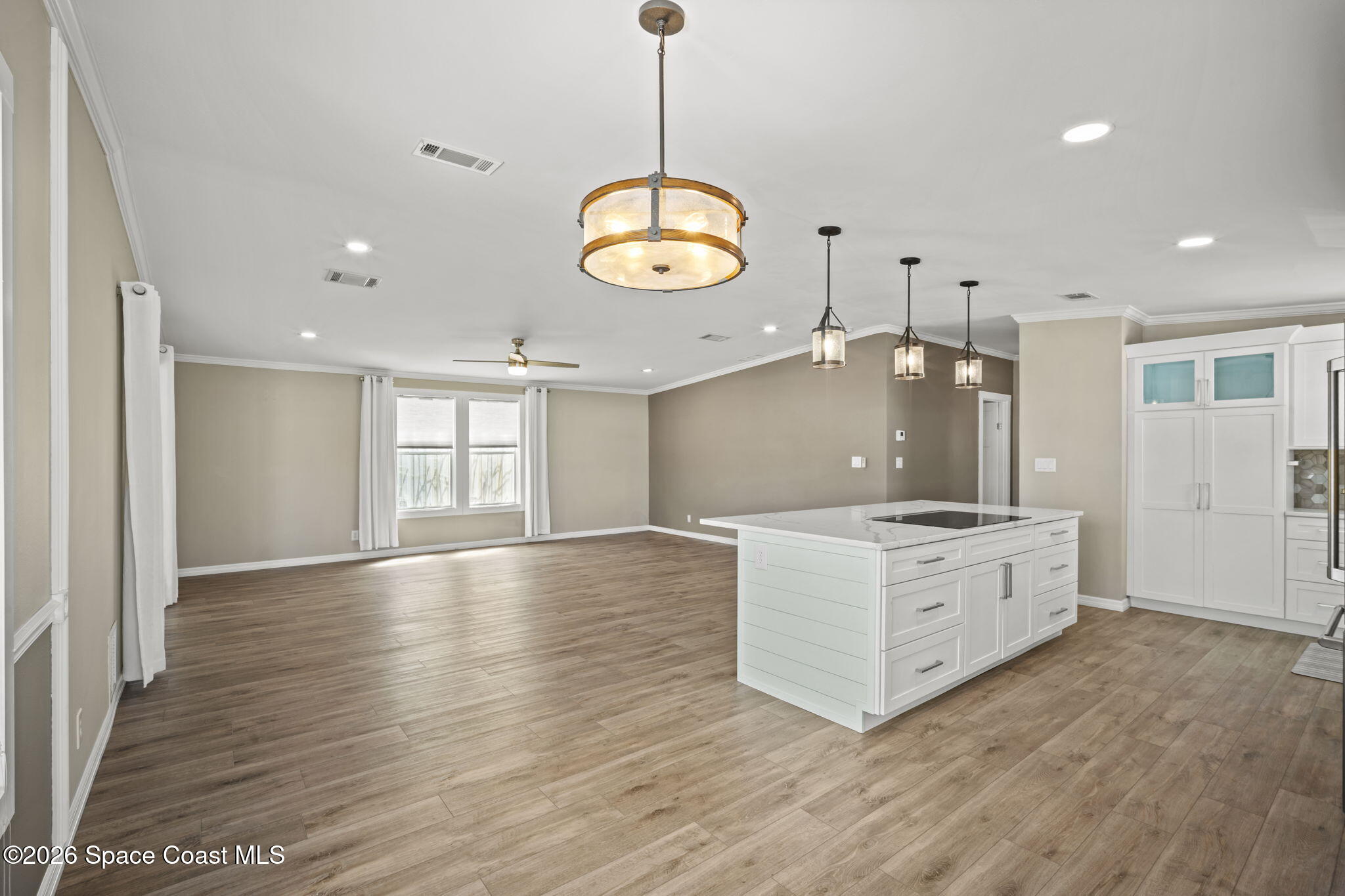 2966 Indian River Drive Northeast Palm Bay, FL 32905 - Photo 14 of 31 a large kitchen with stainless steel appliances granite countertop a stove oven and a wooden floors