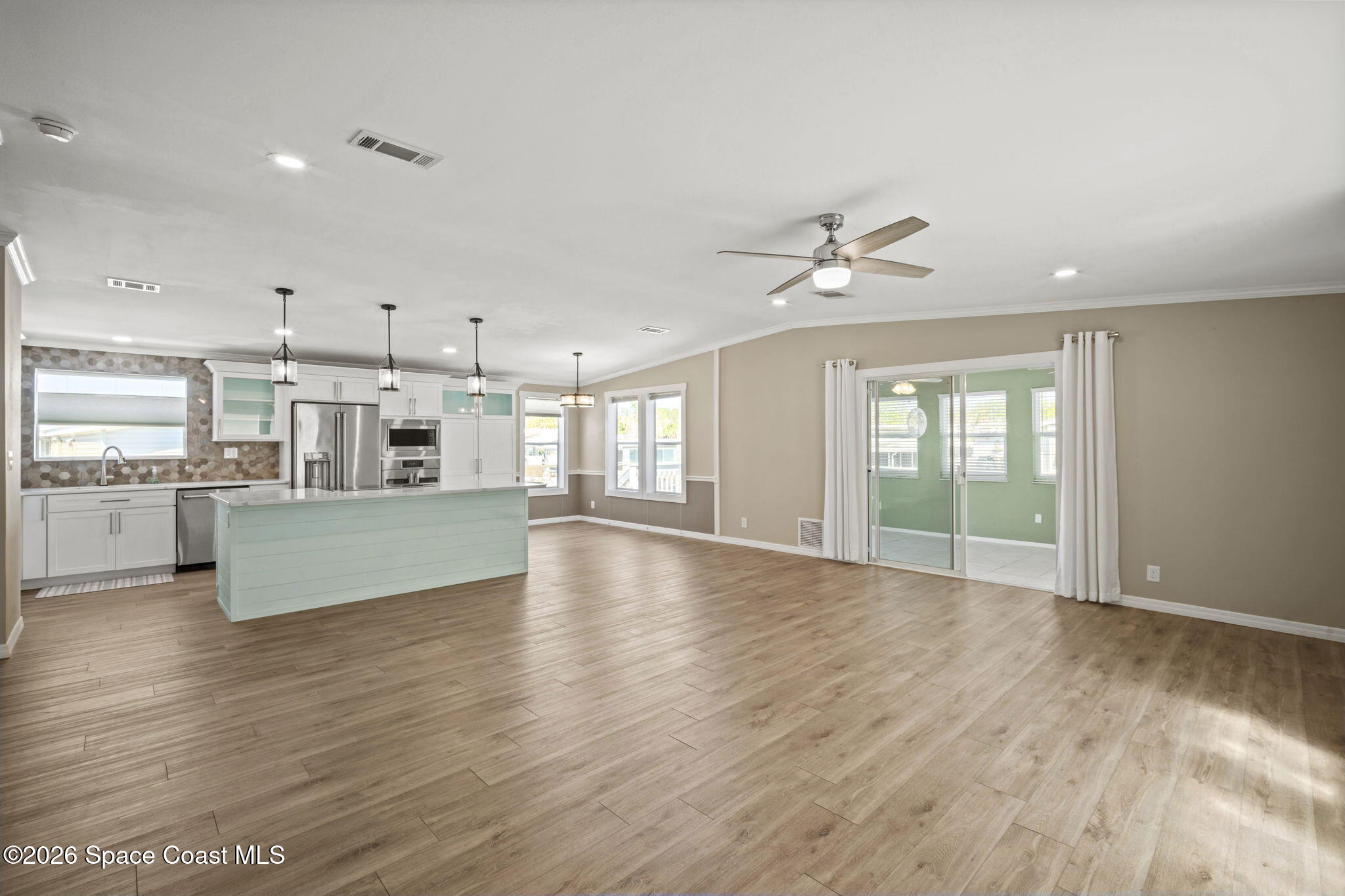 2966 Indian River Drive Northeast Palm Bay, FL 32905 - Photo 16 of 31 a view of an empty room with window and wooden floor