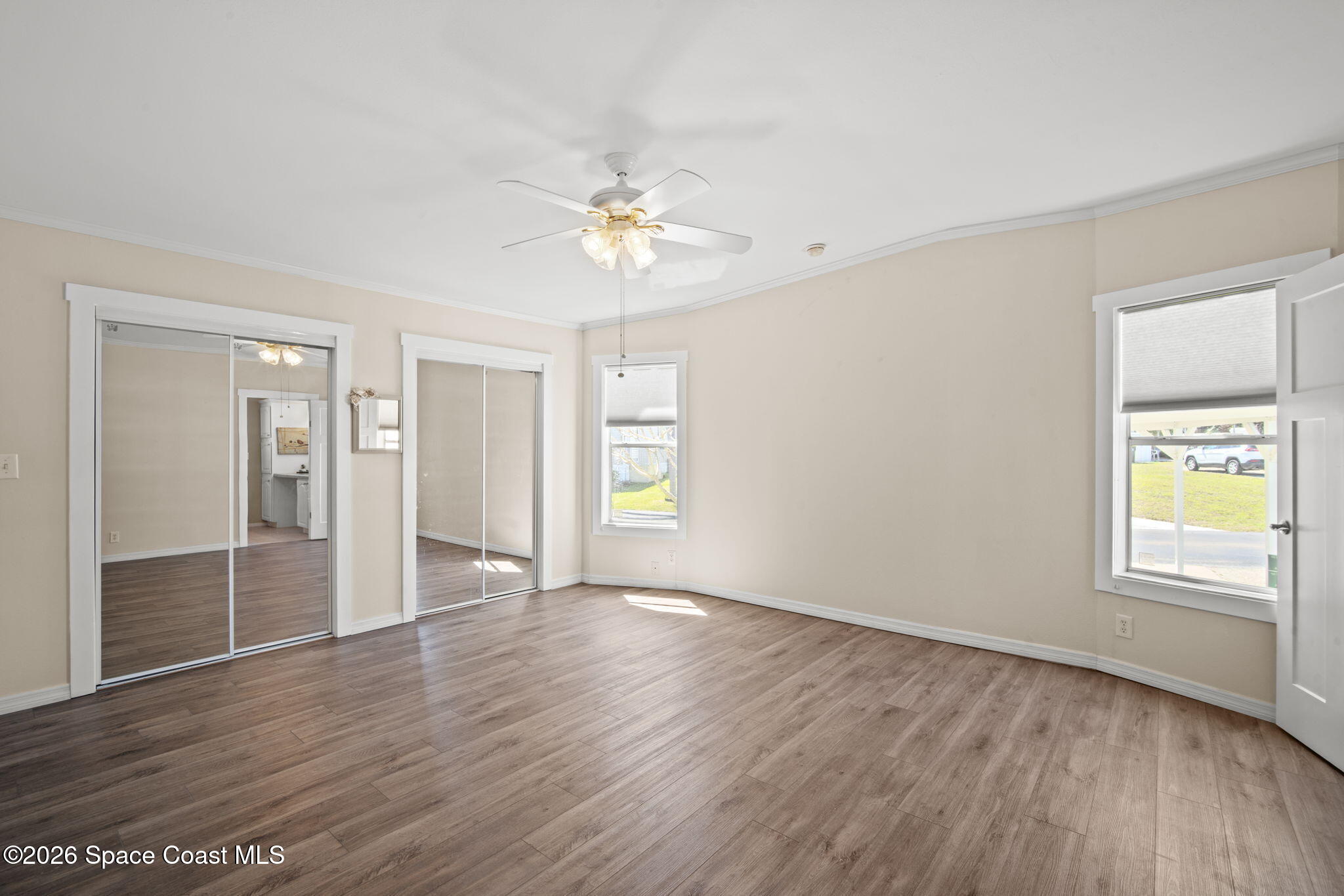 2966 Indian River Drive Northeast Palm Bay, FL 32905 - Photo 17 of 31 a view of an empty room with a window and wooden floor