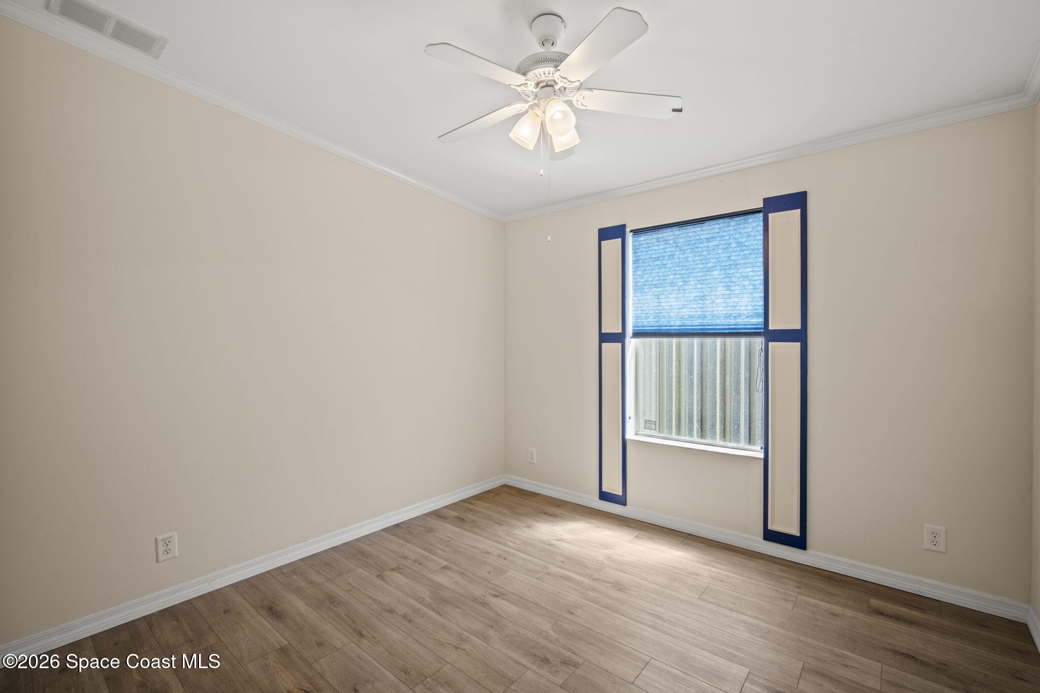 2966 Indian River Drive Northeast Palm Bay, FL 32905 - Photo 19 of 31 wooden floor in an empty room with a window