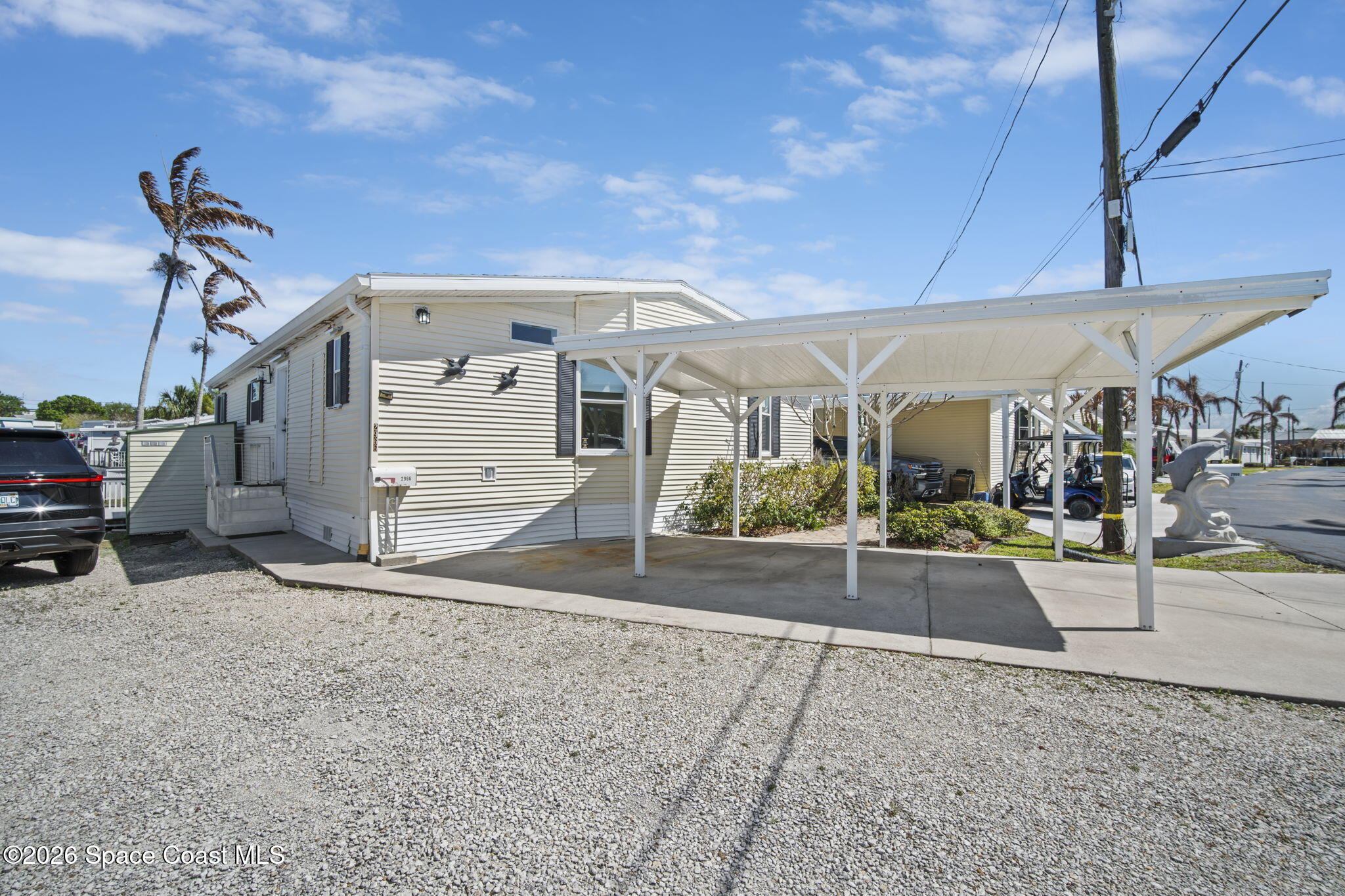 2966 Indian River Drive Northeast Palm Bay, FL 32905 - Photo 2 of 31 a view of a house with a garage