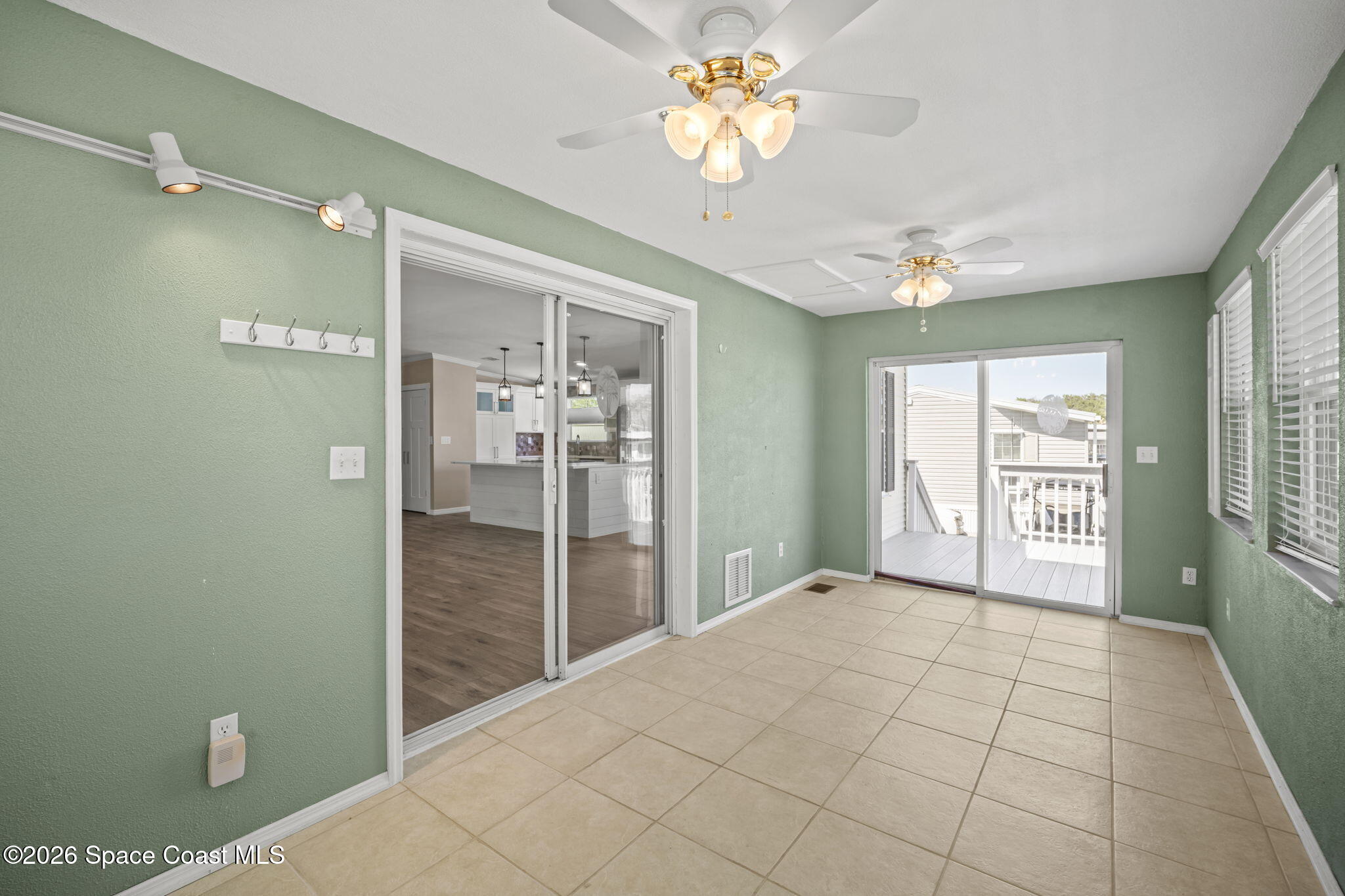 2966 Indian River Drive Northeast Palm Bay, FL 32905 - Photo 22 of 31 a view of a hallway with a chandelier fan and windows