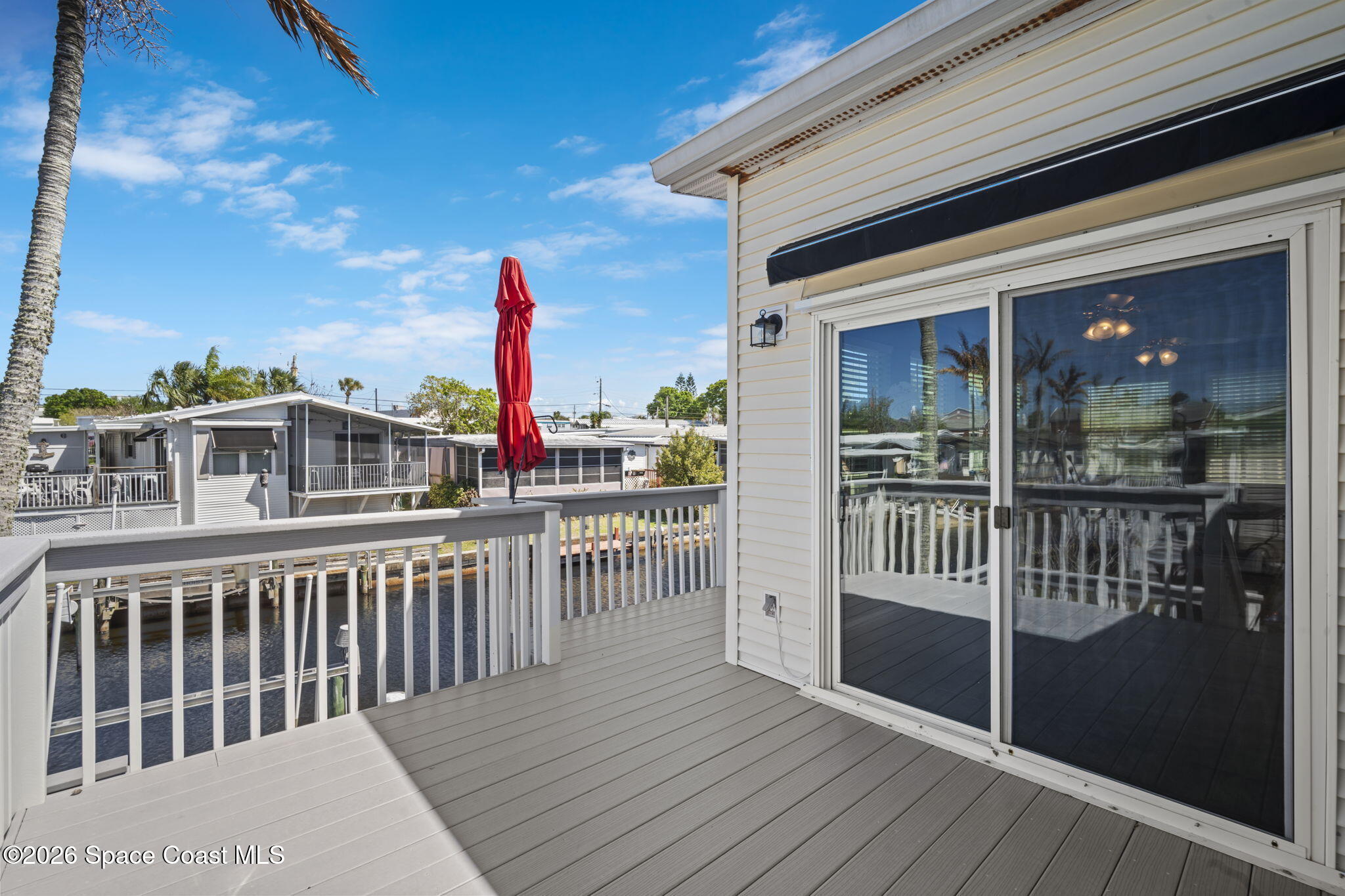 2966 Indian River Drive Northeast Palm Bay, FL 32905 - Photo 24 of 31 a view of a balcony with wooden floor and fence