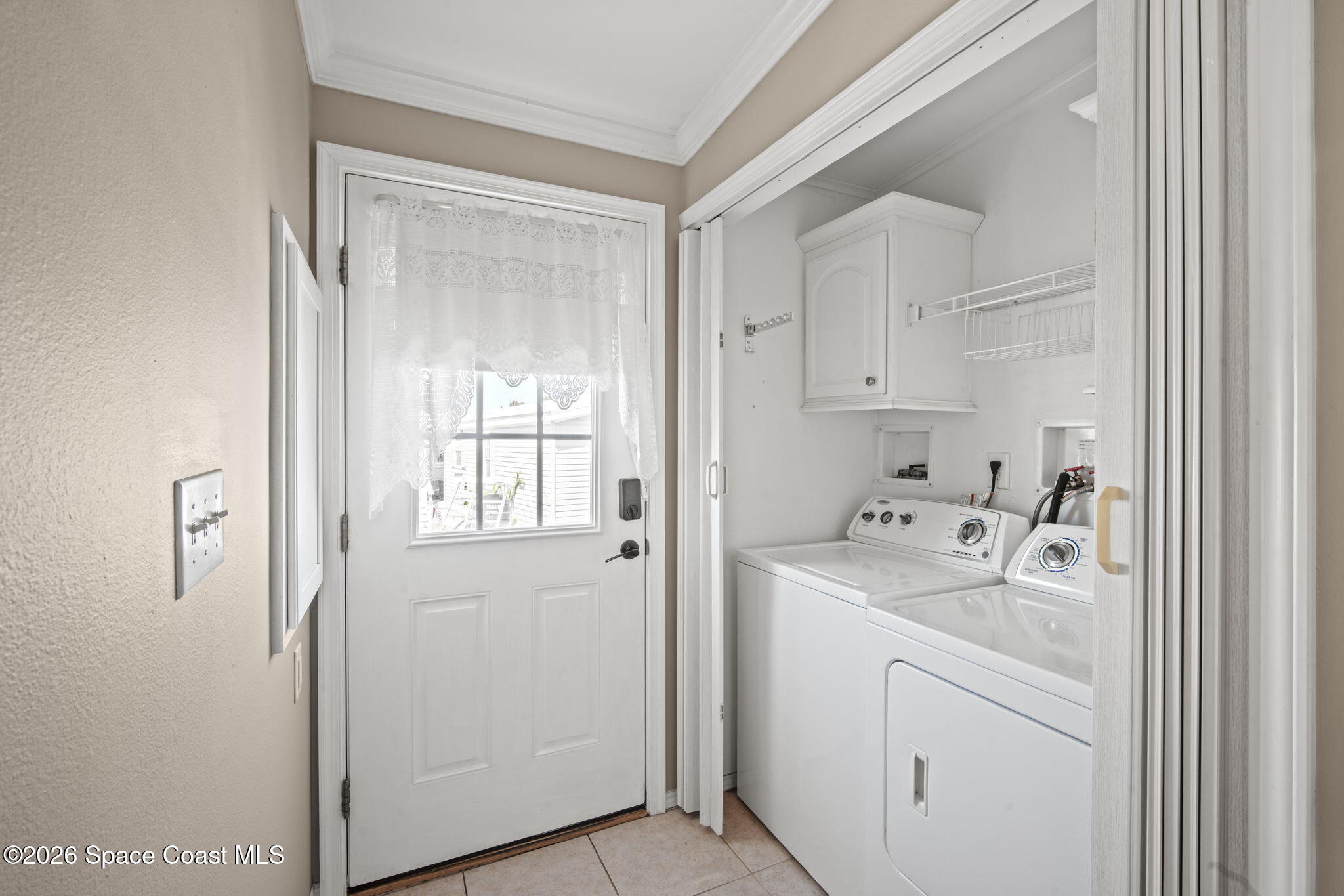 2966 Indian River Drive Northeast Palm Bay, FL 32905 - Photo 3 of 31 a utility room with cabinets washer and dryer