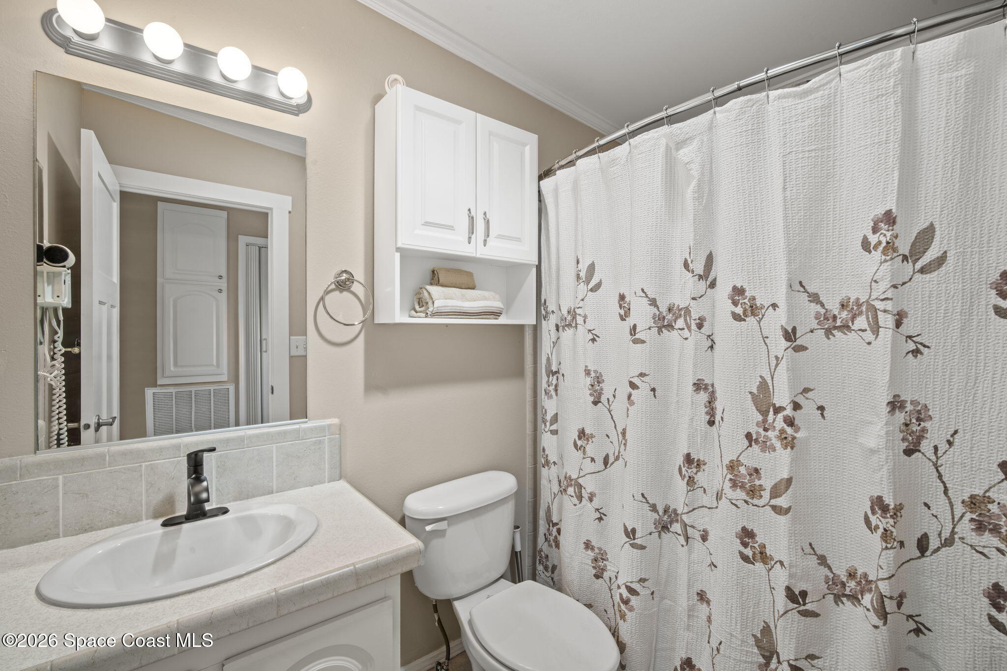 2966 Indian River Drive Northeast Palm Bay, FL 32905 - Photo 5 of 31 a bathroom with a sink toilet and shower