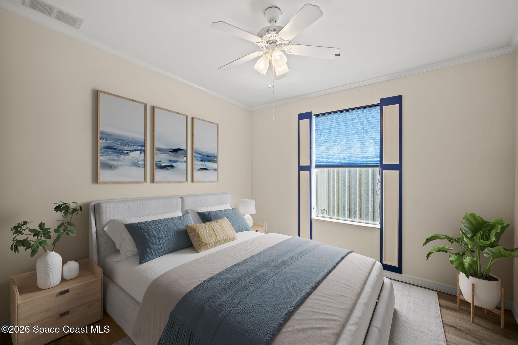 2966 Indian River Drive Northeast Palm Bay, FL 32905 - Photo 6 of 31 a bedroom with a large bed and a chandelier fan