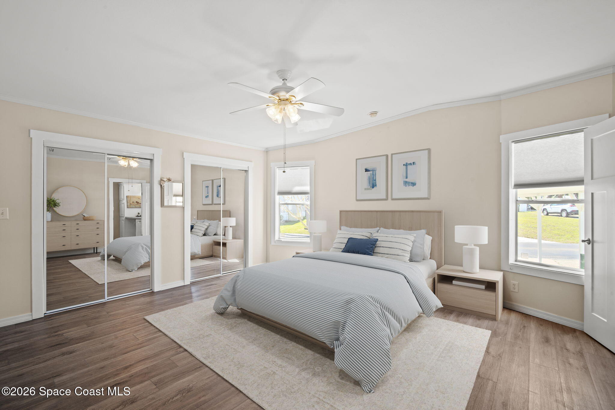 2966 Indian River Drive Northeast Palm Bay, FL 32905 - Photo 7 of 31 a spacious bedroom with a large bed and a chandelier