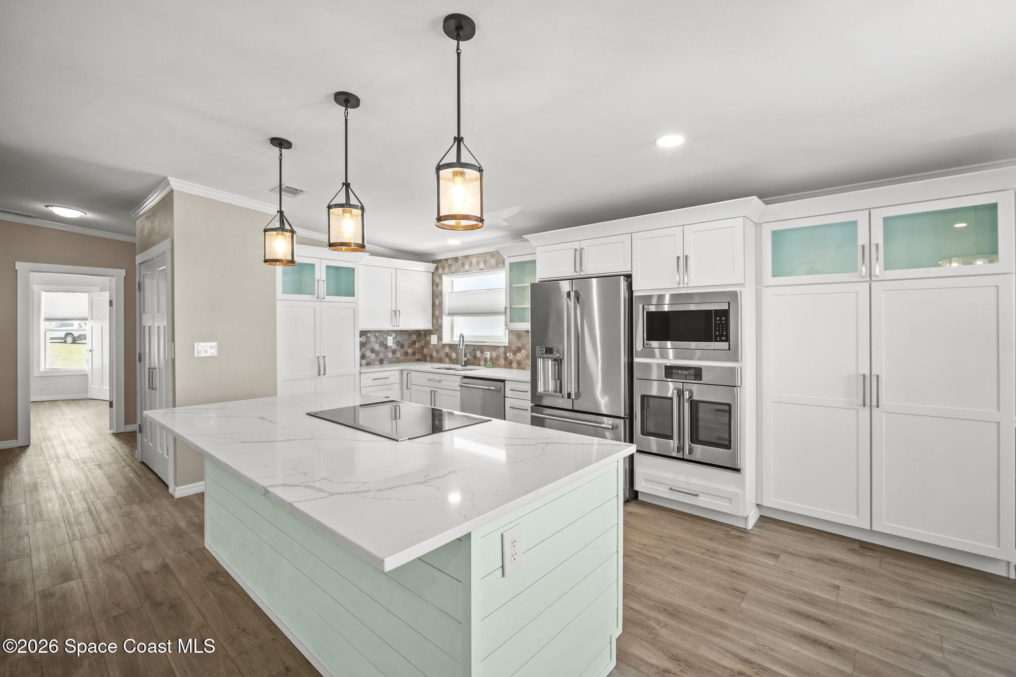 2966 Indian River Drive Northeast Palm Bay, FL 32905 - Photo 10 of 31 a kitchen with stainless steel appliances a stove a refrigerator and island