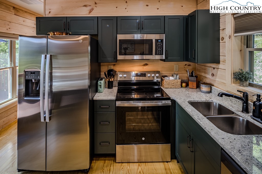 225 Oak Road Beech Mountain, NC 28604 - Photo 11 of 31 a kitchen with a refrigerator stove and sink