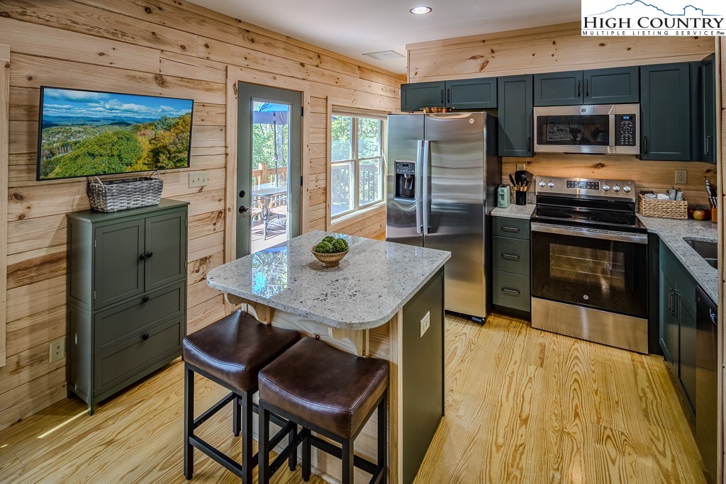 225 Oak Road Beech Mountain, NC 28604 - Photo 12 of 31 a kitchen with stainless steel appliances granite countertop a stove refrigerator and a stove