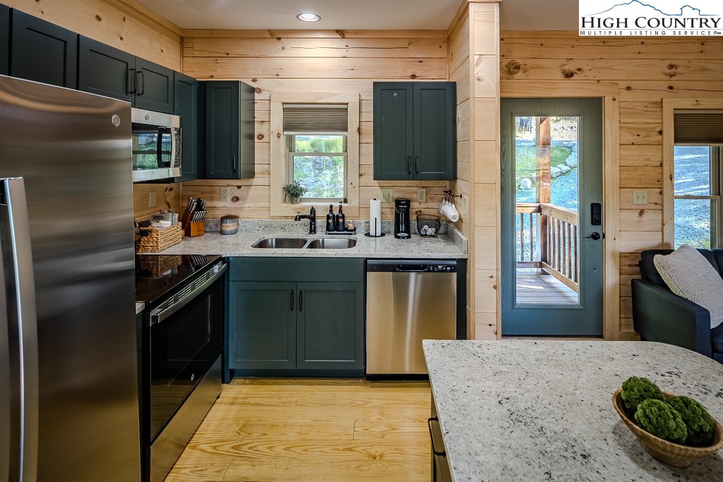 225 Oak Road Beech Mountain, NC 28604 - Photo 15 of 31 a kitchen with stainless steel appliances granite countertop a sink a stove a refrigerator and a refrigerator
