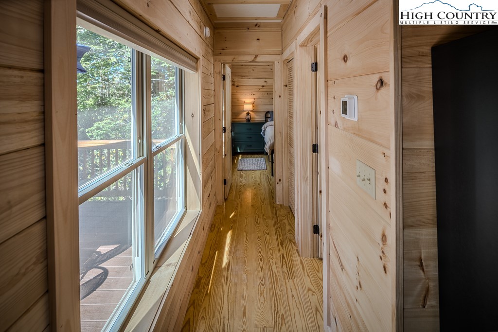 225 Oak Road Beech Mountain, NC 28604 - Photo 17 of 31 a view of a hallway with wooden floor and staircase