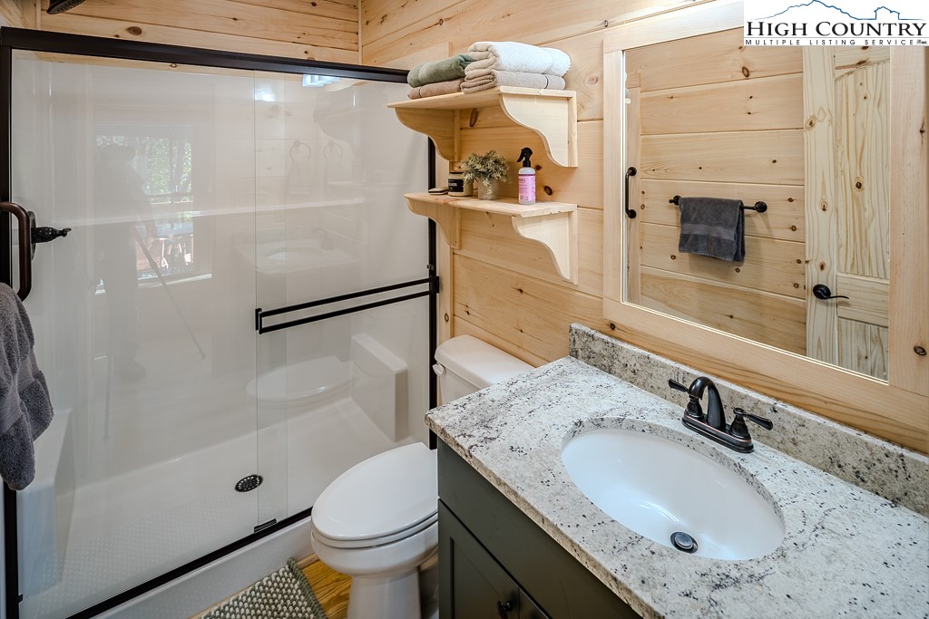 225 Oak Road Beech Mountain, NC 28604 - Photo 18 of 31 a bathroom with a granite countertop sink toilet and shower