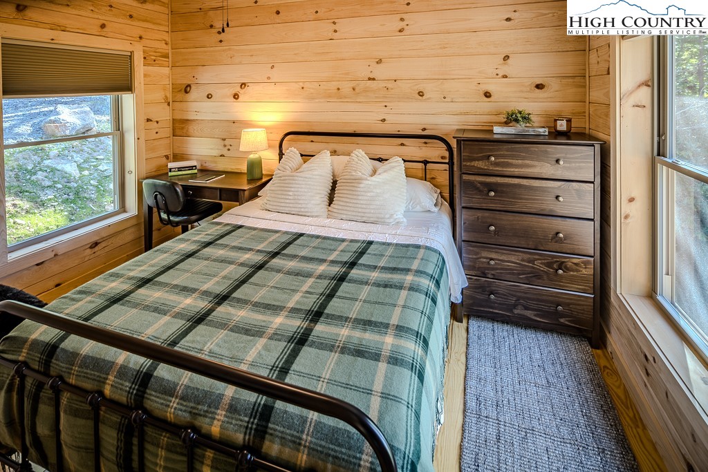 225 Oak Road Beech Mountain, NC 28604 - Photo 22 of 31 a bedroom with a bed and a window