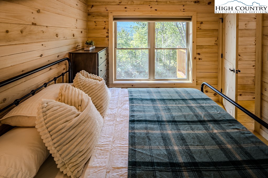 225 Oak Road Beech Mountain, NC 28604 - Photo 23 of 31 a bed sitting in a bedroom next to a window