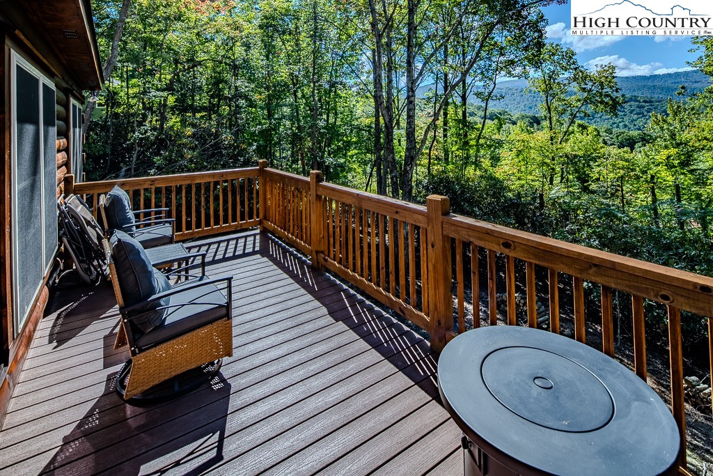 225 Oak Road Beech Mountain, NC 28604 - Photo 3 of 31 a view of balcony with wooden floor and outdoor seating