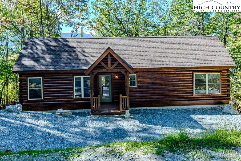 225 Oak Road Beech Mountain, NC 28604 - Photo 4 of 31 a front view of a house with garden
