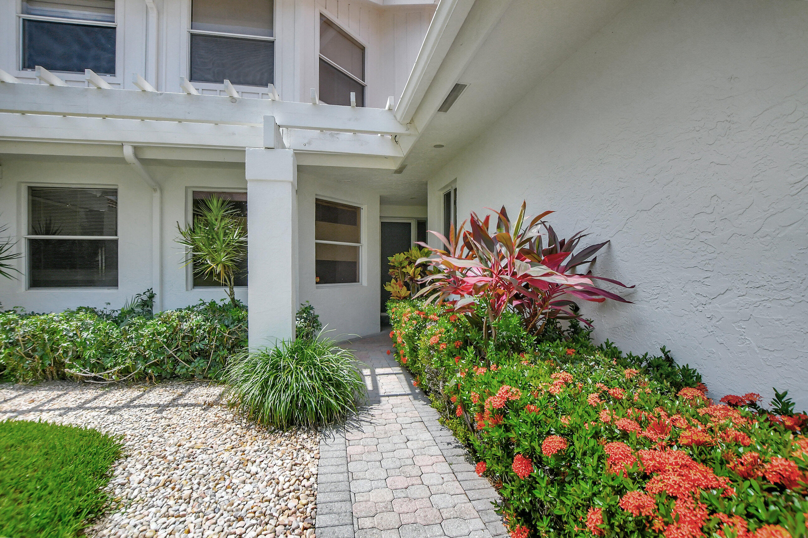 5801 Northwest 24th Avenue, Unit 1004 Boca Raton, FL 33496 - Photo 11 of 65 a vase of flowers sitting in front of a house