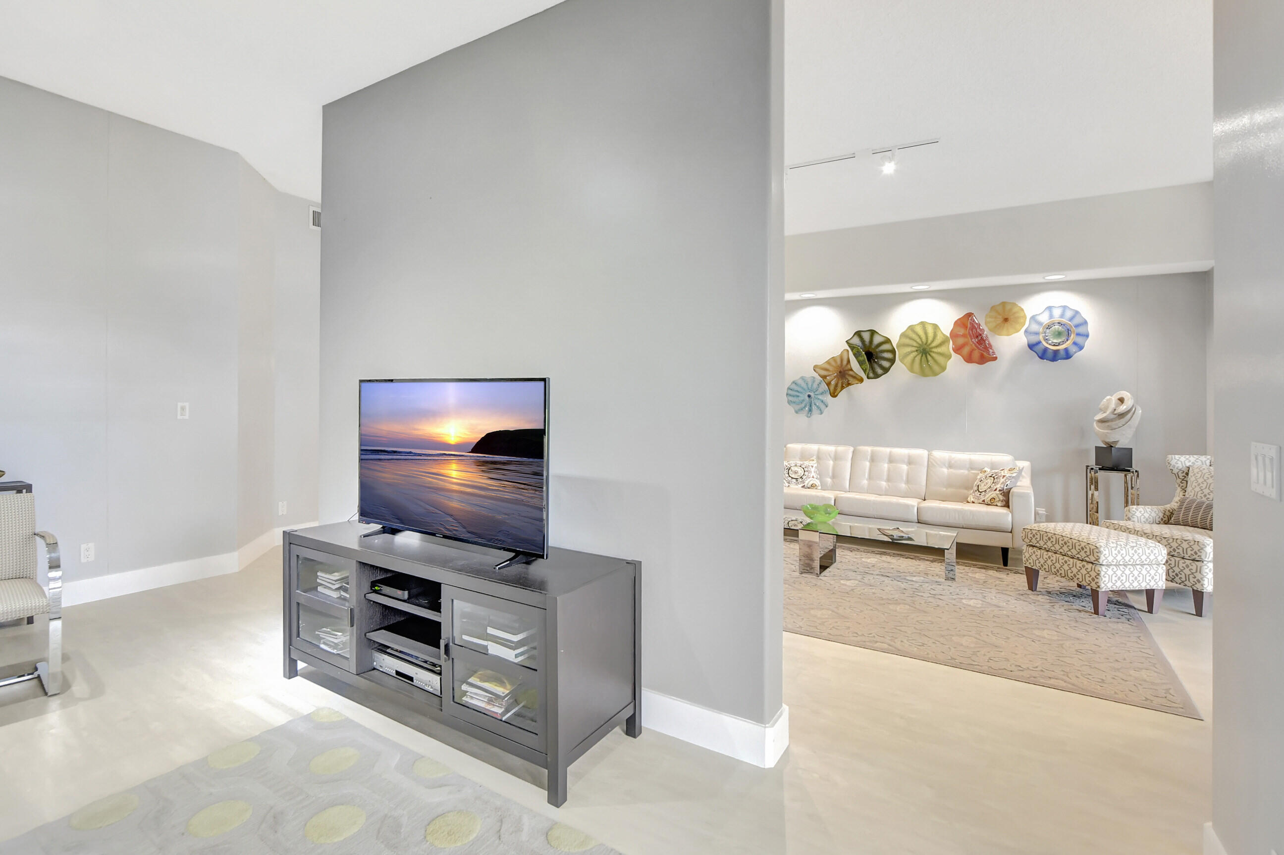 5801 Northwest 24th Avenue, Unit 1004 Boca Raton, FL 33496 - Photo 24 of 65 a living room with furniture and a flat screen tv