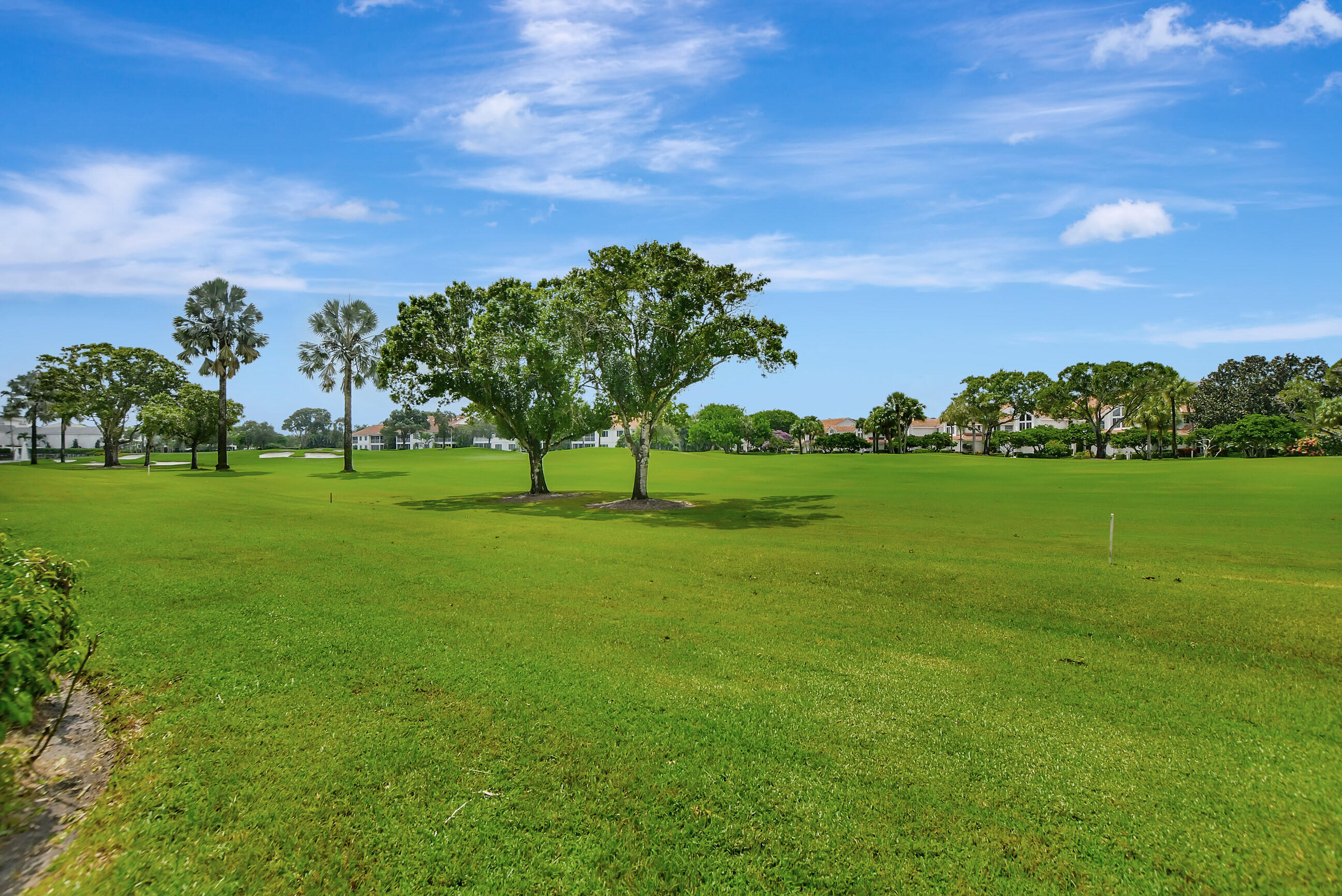 5801 Northwest 24th Avenue, Unit 1004 Boca Raton, FL 33496 - Photo 30 of 65 a view of a golf course with a garden