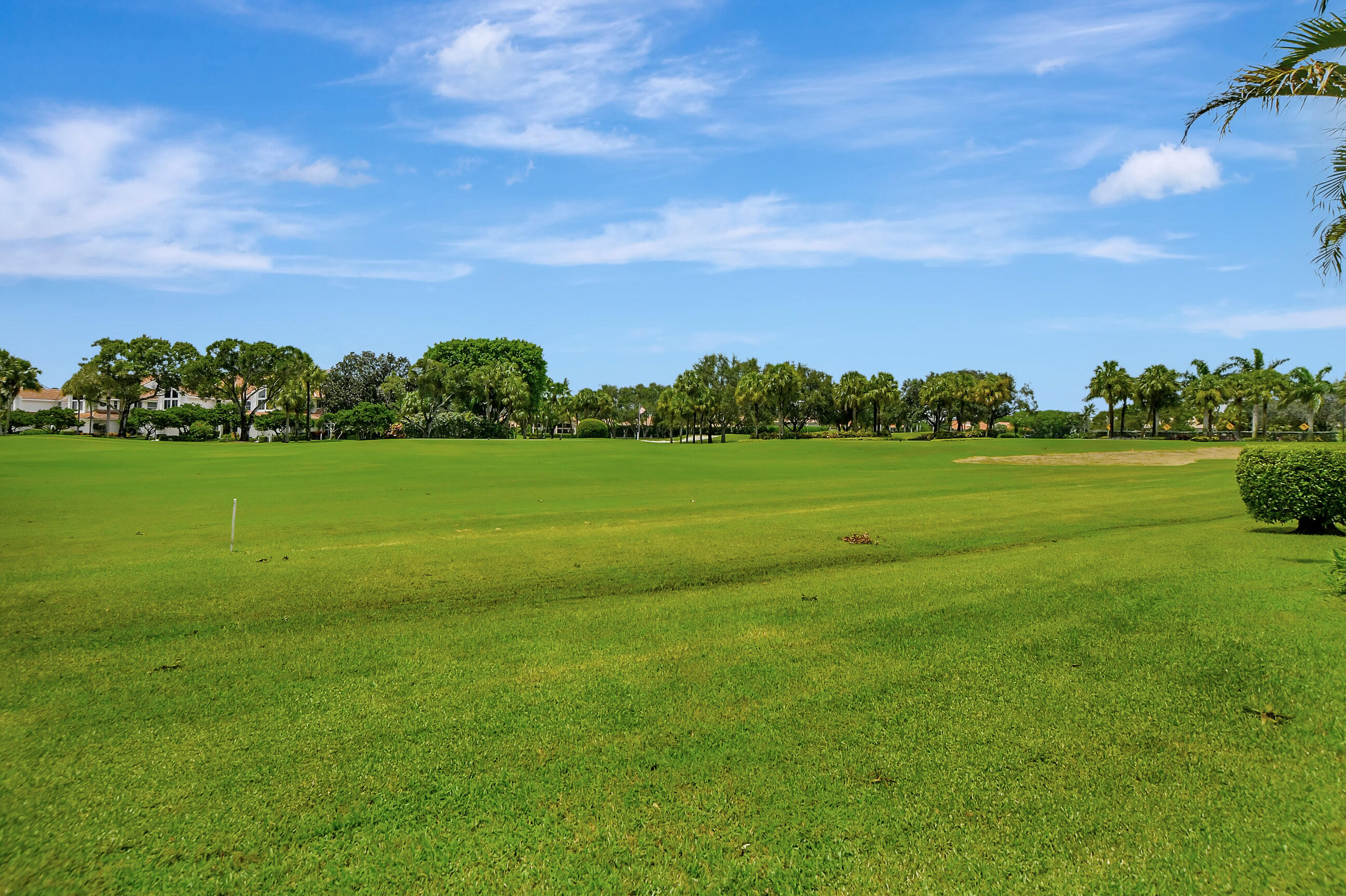 5801 Northwest 24th Avenue, Unit 1004 Boca Raton, FL 33496 - Photo 31 of 65 a view of a grassy field with an trees